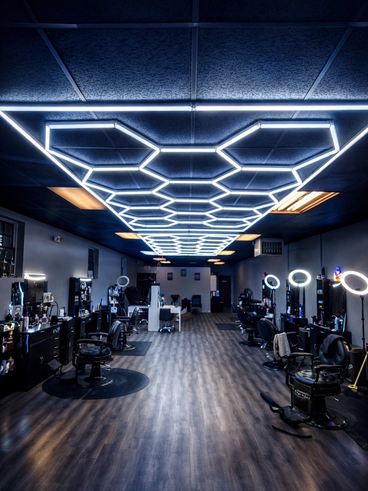 Studio Blends interior with hexagonal LED lighting and barber chairs